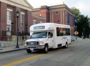 An inbound Joseph's Limousine bus on the MBTA route on Forest Street at Medford Square in July 2015