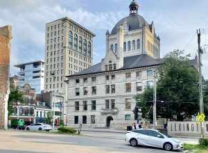On the left, built in 1898-1900, this Richardsonian Romanesque Revival-style building was designed by Lehman and Schmitt to serve as the Fayette County Courthouse, and is the fifth courthouse to serve Fayette County, replacing a previous courthouse,
