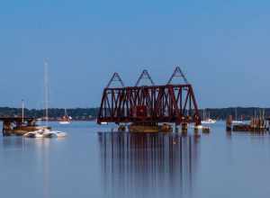 An evening image of the open Back Cove swing bridge.

The rail swing bridge and trestle was built in 1848 when the Atlantic &amp; St. Lawrence railroad began service from Portland to Yarmouth Maine. To cross the Portland peninsula, the trestle was