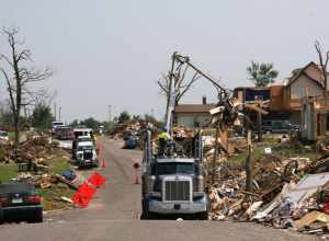 Contracted haul trucks work to remove millions of cubic yards of debris which line the streets of Joplin, Mo., after the EF5 tornado touched down on May 22. The Corps of Engineers was tasked with the debris removal and disposal mission by FEMA. 
U.S.