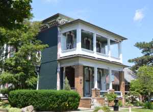 Front and western side of the George and Helen Tate House, located at 114 E. Jefferson Street in Kokomo, Indiana, United States.  Built in 1878, it is listed on the National Register of Historic Places.