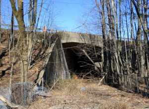 Abandoned underpass that formerly carried the Center Street Branch of the Meriden, Waterbury and Connecticut River Railroad under I-691 in Meriden, seen in March 2023