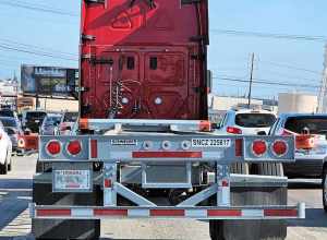 Schneider National shipping container semi-trailer from the rear on I-710 in Bell, California, USA.