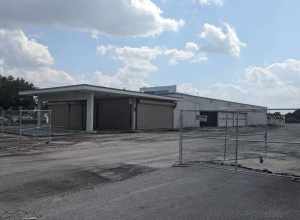 The former Sears Auto Center in Melbourne, Florida surrounded by fencing for demolition work